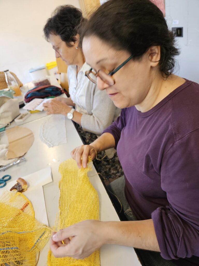 Participante de l’atelier de modélisme et patronage réalisant un projet textile lors d’une séance de création.